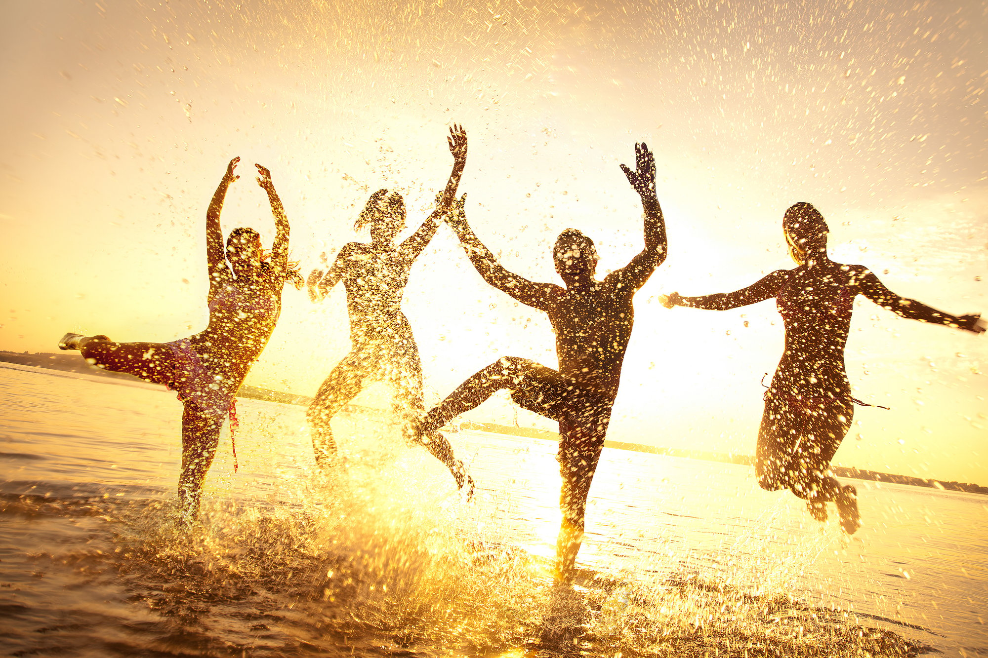 friends dancing at beach