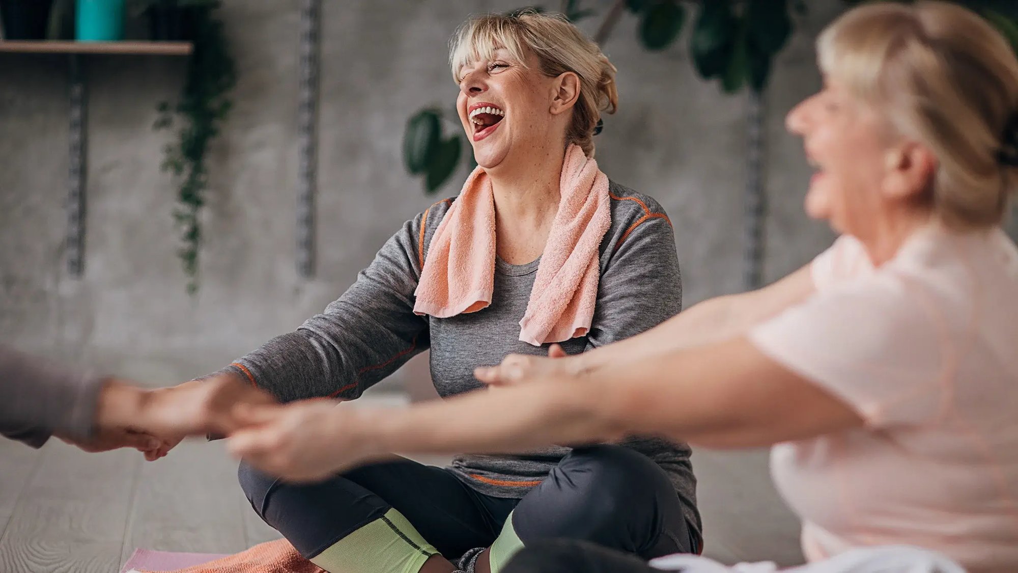 woman_circled_up_laughing_yoga_class-1300669365